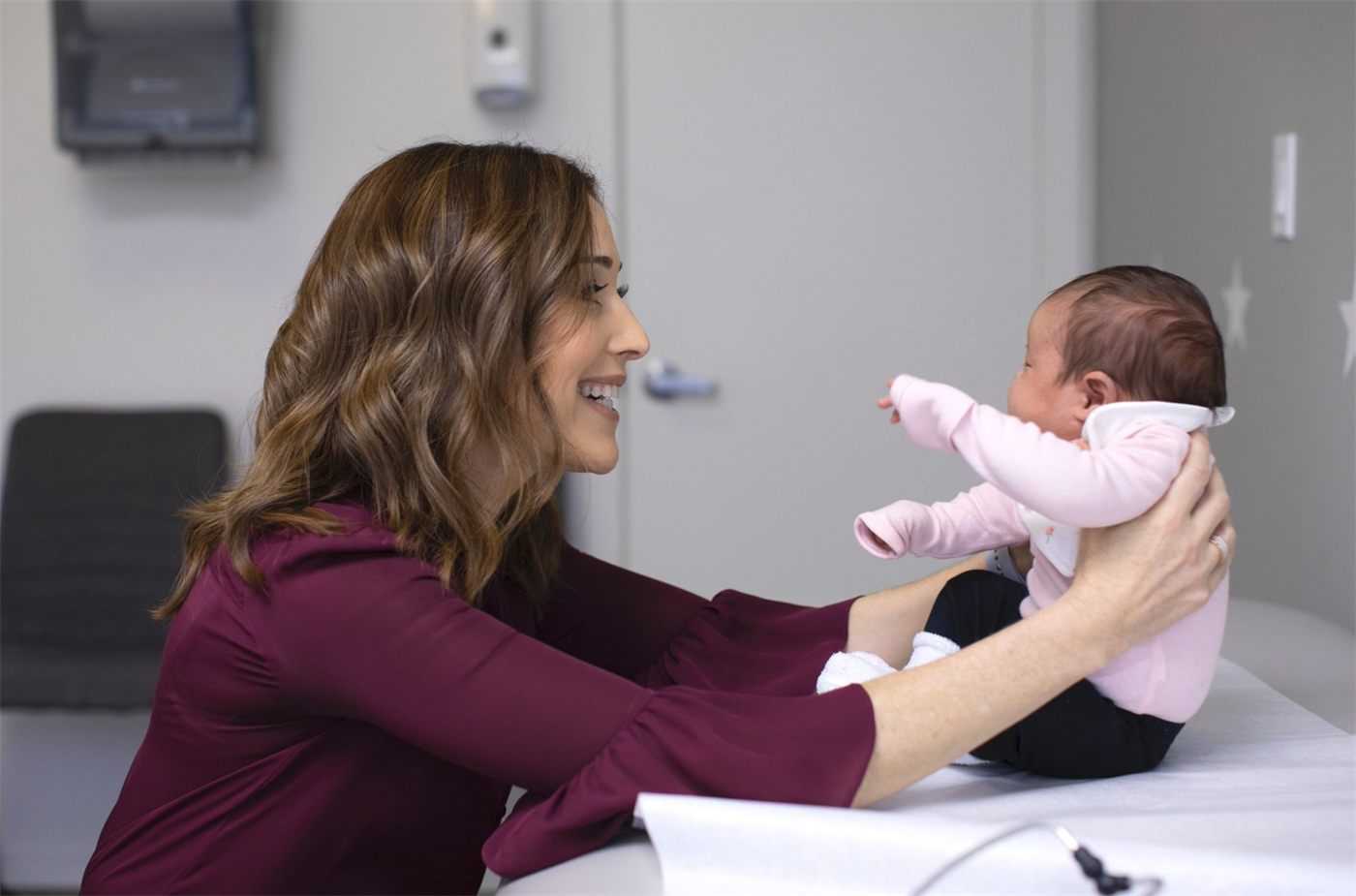 Dr. Tanya Altmann cradling a newborn at Calabasas Pediatrics